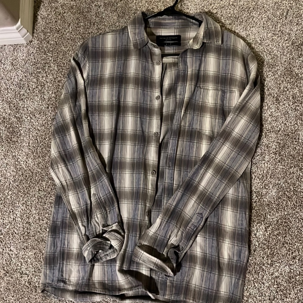 A small flannel with pale colors of green and blue with streaks of white